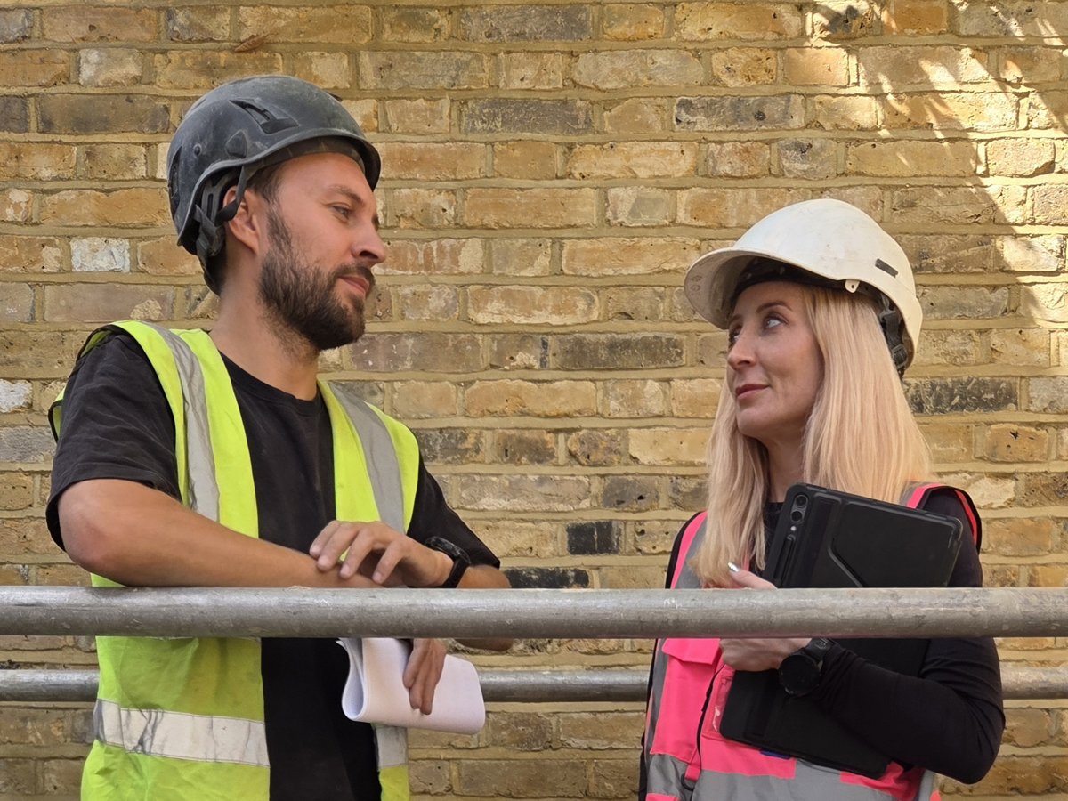 Phil and Jen on site today in hi-vis and hard hats, with drawings, at the current project.